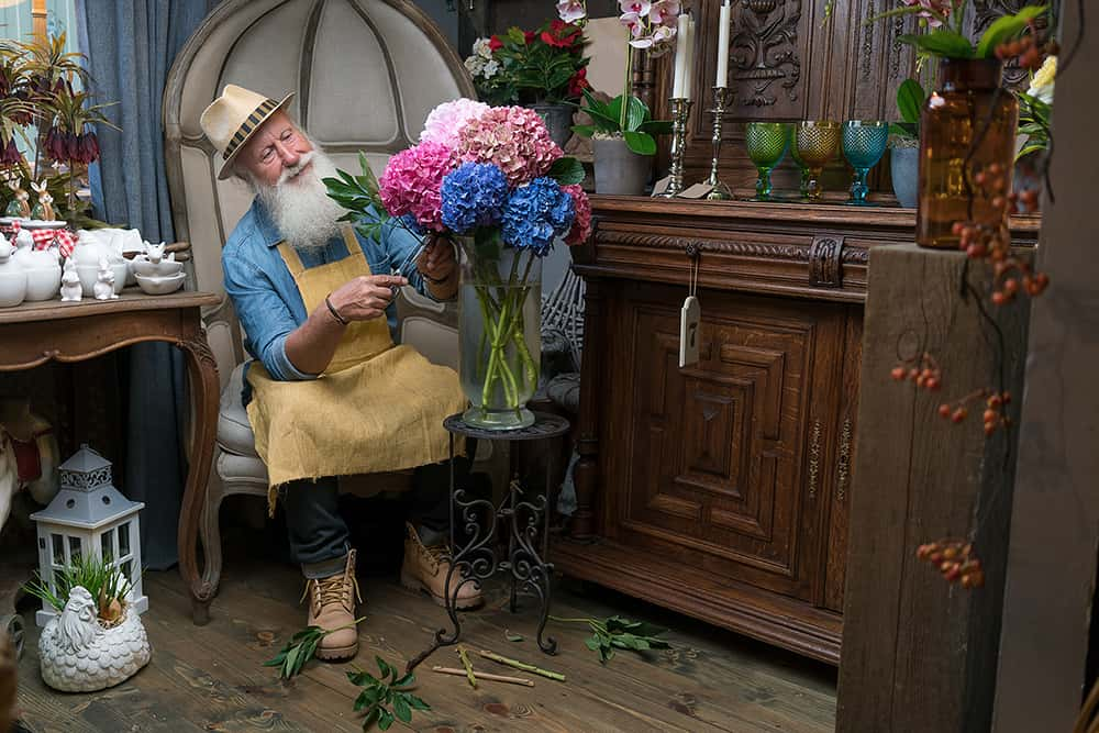 Salty Sam happliy arranging flowers in his flower shop